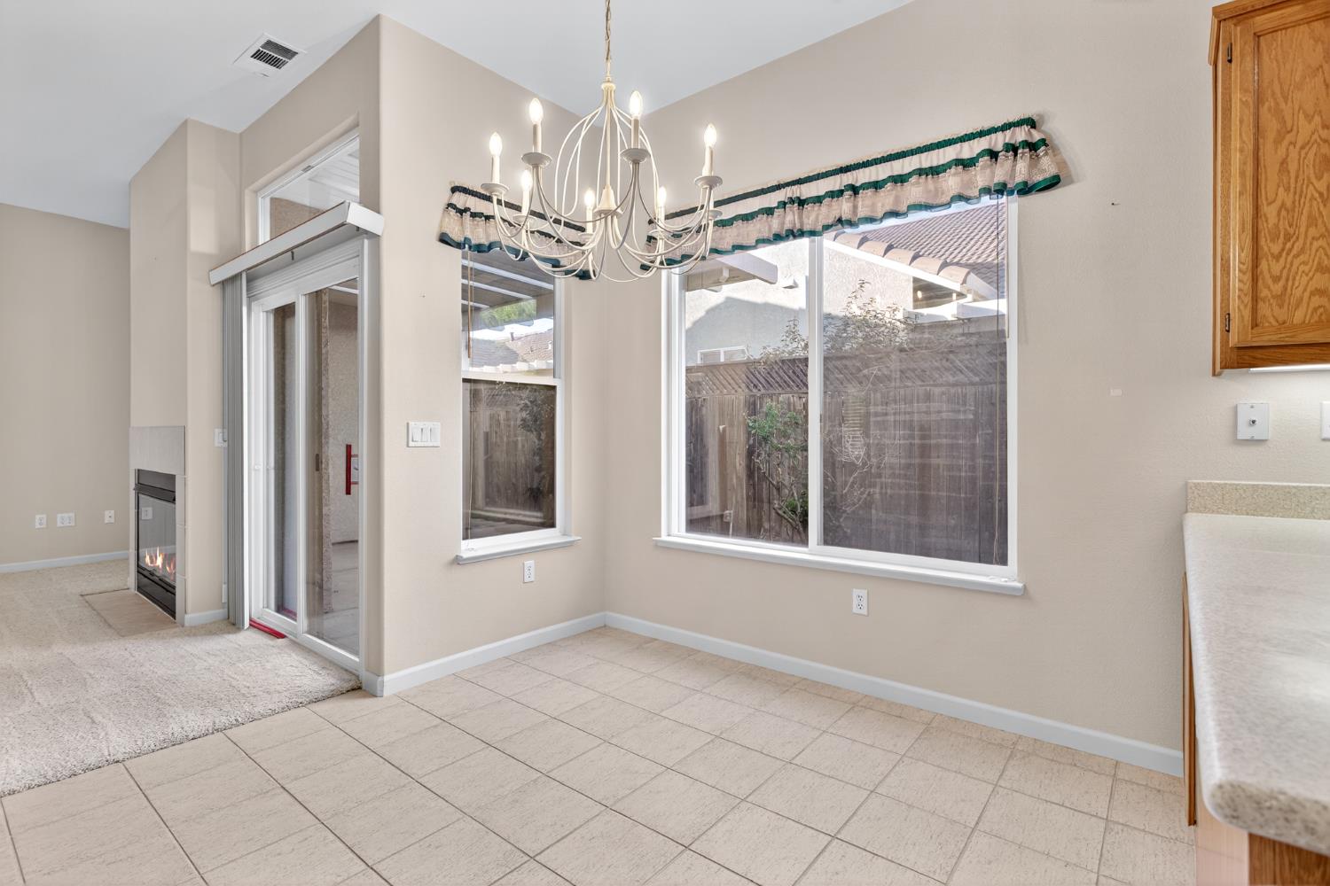 3409 Sugar Oak Court Modesto, CA 95355 - Photo 12 of 28 a view of a big room with chandelier and windows