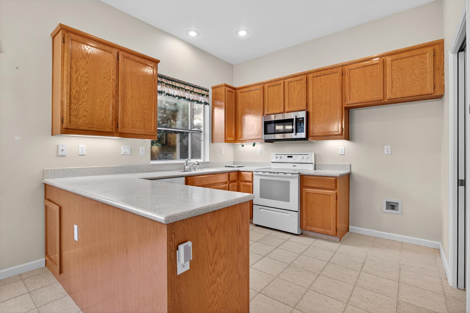 3409 Sugar Oak Court Modesto, CA 95355 - Photo 13 of 28 a kitchen with stainless steel appliances granite countertop a sink stove and refrigerator