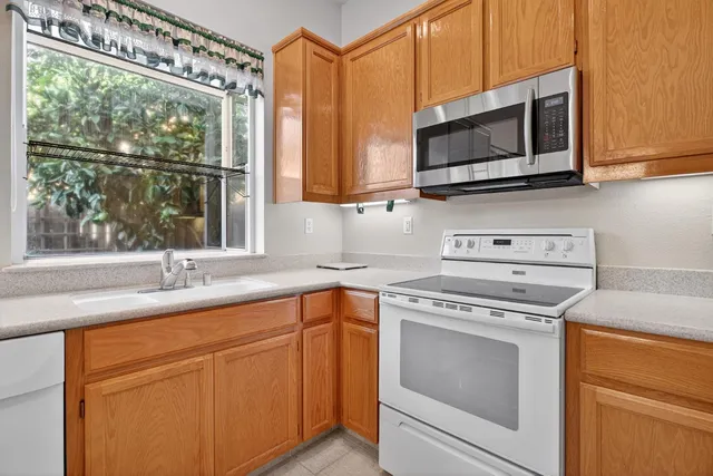 a kitchen with a sink stove and microwave