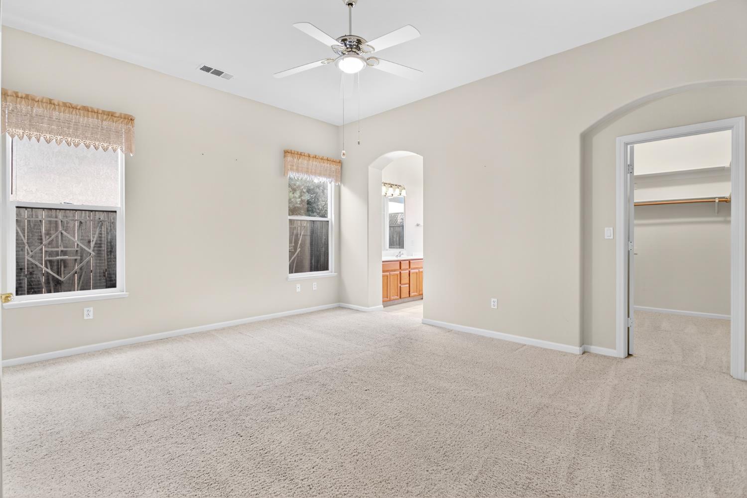 3409 Sugar Oak Court Modesto, CA 95355 - Photo 16 of 28 an empty room with windows and fan