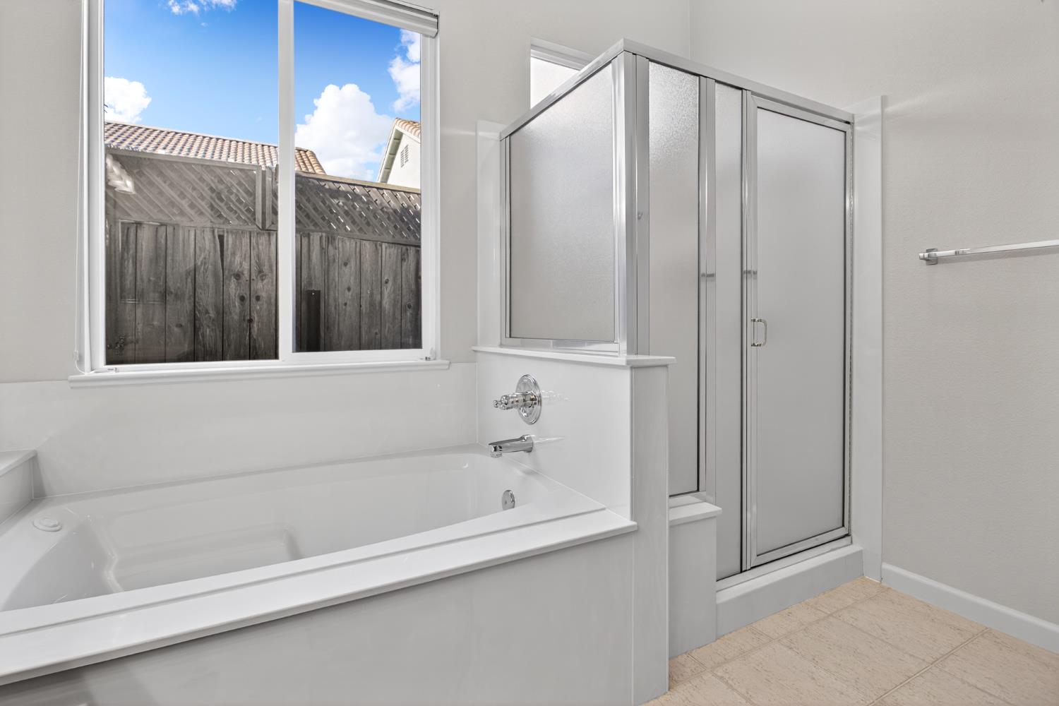 3409 Sugar Oak Court Modesto, CA 95355 - Photo 20 of 28 a bathroom with a bathtub and a shower