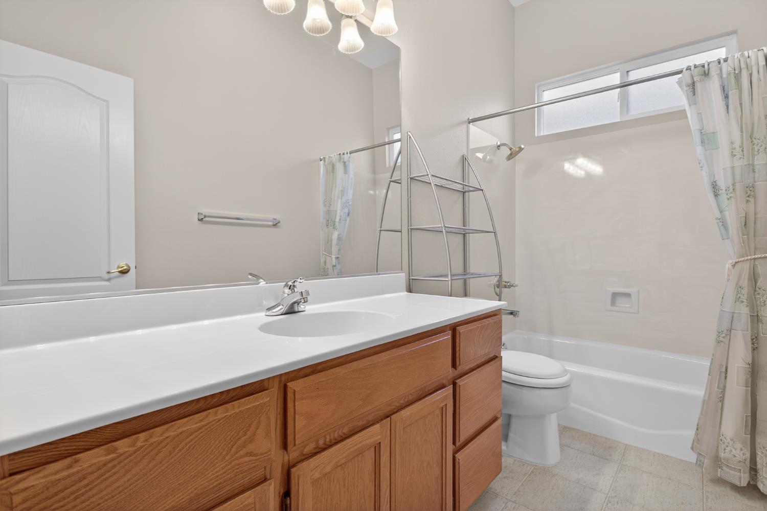 3409 Sugar Oak Court Modesto, CA 95355 - Photo 23 of 28 a bathroom with a sink and a mirror