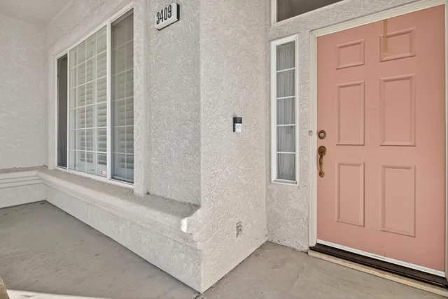 an entryway with chandelier and a window