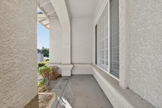 a large white room with potted plants