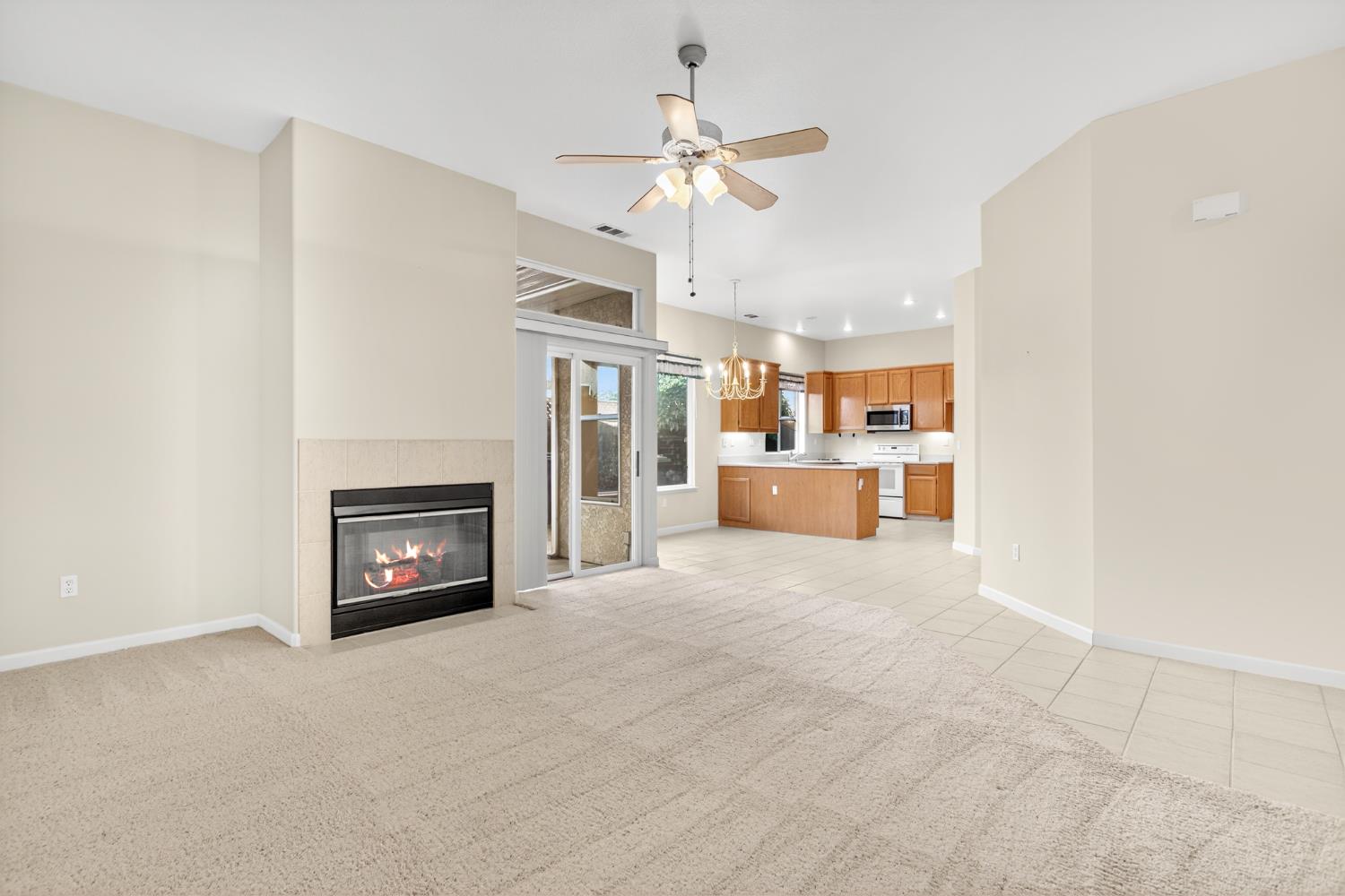 3409 Sugar Oak Court Modesto, CA 95355 - Photo 9 of 28 a view of a kitchen with a sink and a fireplace