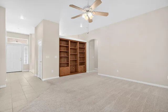 an empty room with a empty space and windows