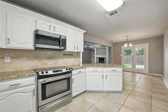 a kitchen with cabinets stainless steel appliances and a sink