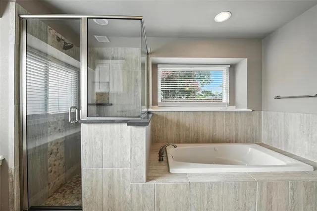 a bathroom with a bathtub and a shower