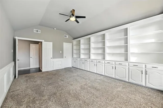 a view of an empty room with a kitchen