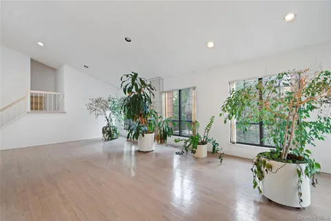 a view of empty room with a window and fireplace