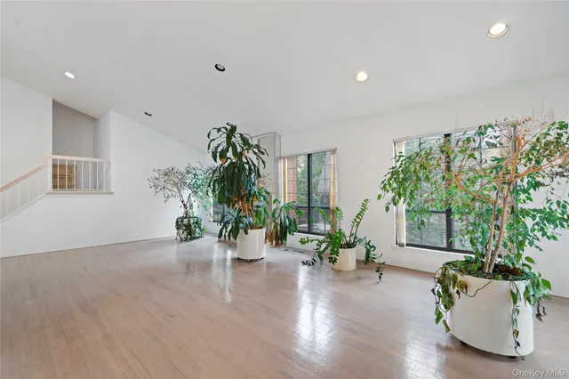 a view of empty room with a window and fireplace