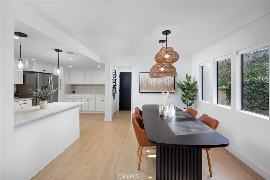 910 Ocean View Avenue, Unit E Monrovia, CA 91016 - Photo 11 of 39 a kitchen with a table chairs and a living room view
