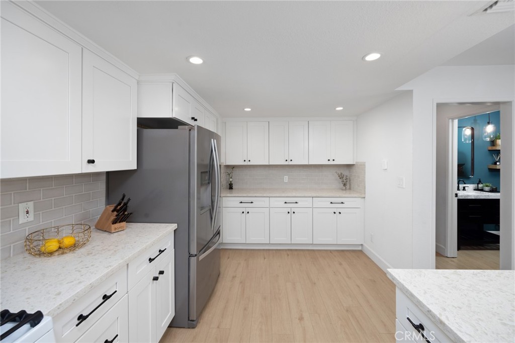 910 Ocean View Avenue, Unit E Monrovia, CA 91016 - Photo 16 of 39 a kitchen with a refrigerator and a stove top oven