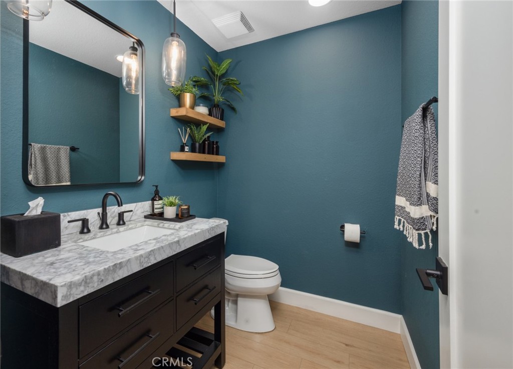 910 Ocean View Avenue, Unit E Monrovia, CA 91016 - Photo 17 of 39 a bathroom with a granite countertop sink a toilet and a mirror