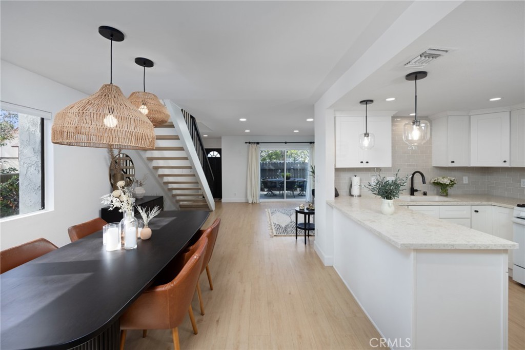 910 Ocean View Avenue, Unit E Monrovia, CA 91016 - Photo 18 of 39 a large white kitchen with a large window a sink and stainless steel appliances