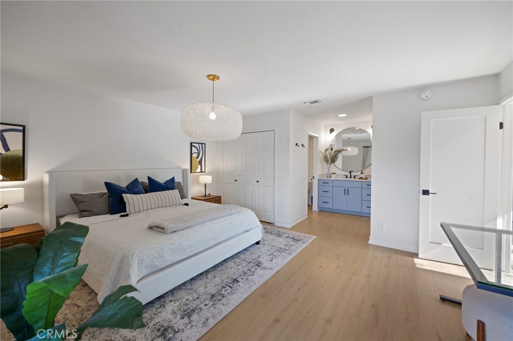 910 Ocean View Avenue, Unit E Monrovia, CA 91016 - Photo 20 of 39 a bedroom with a bed and a view of bathroom