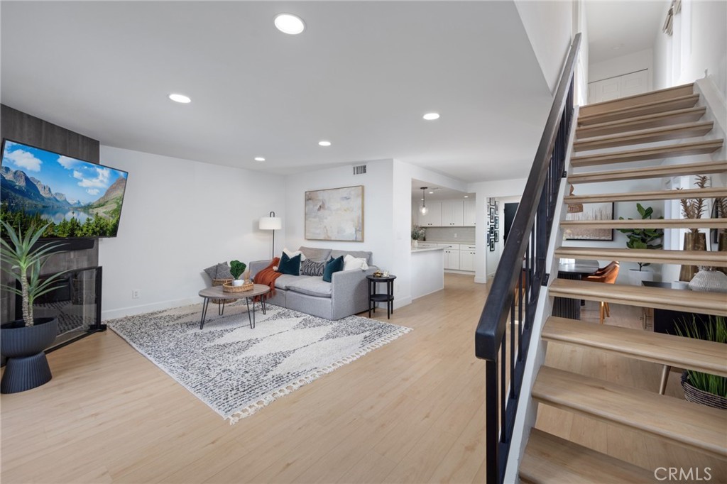 910 Ocean View Avenue, Unit E Monrovia, CA 91016 - Photo 5 of 39 a living room with furniture a rug and a potted plant