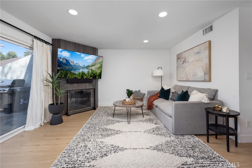 910 Ocean View Avenue, Unit E Monrovia, CA 91016 - Photo 7 of 39 a living room with furniture and a flat screen tv