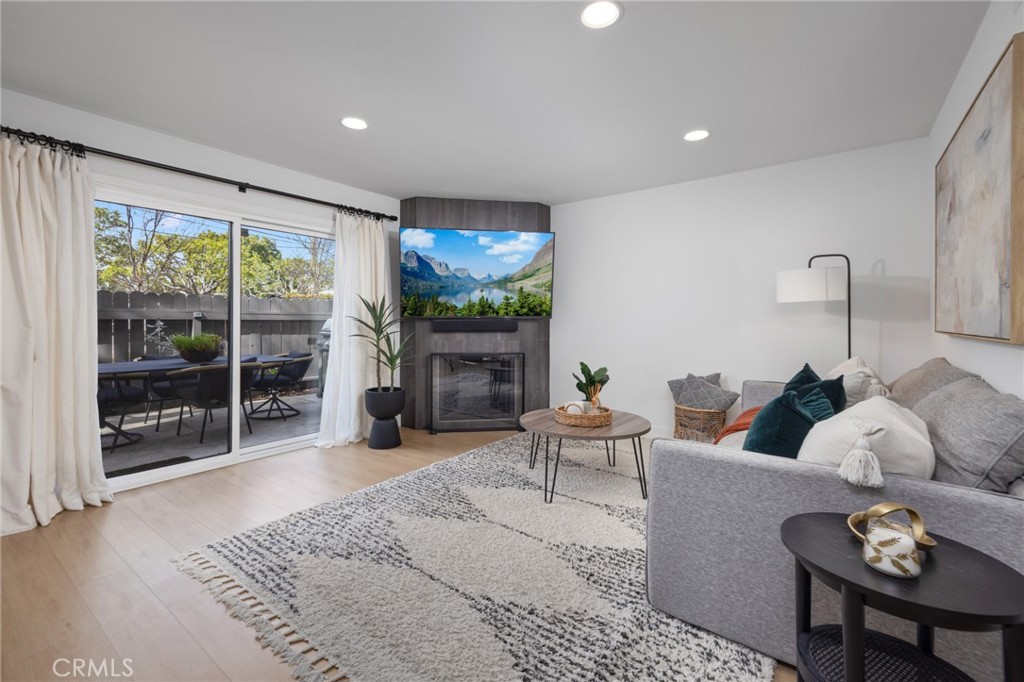 910 Ocean View Avenue, Unit E Monrovia, CA 91016 - Photo 8 of 39 a living room with furniture a fireplace and a floor to ceiling window