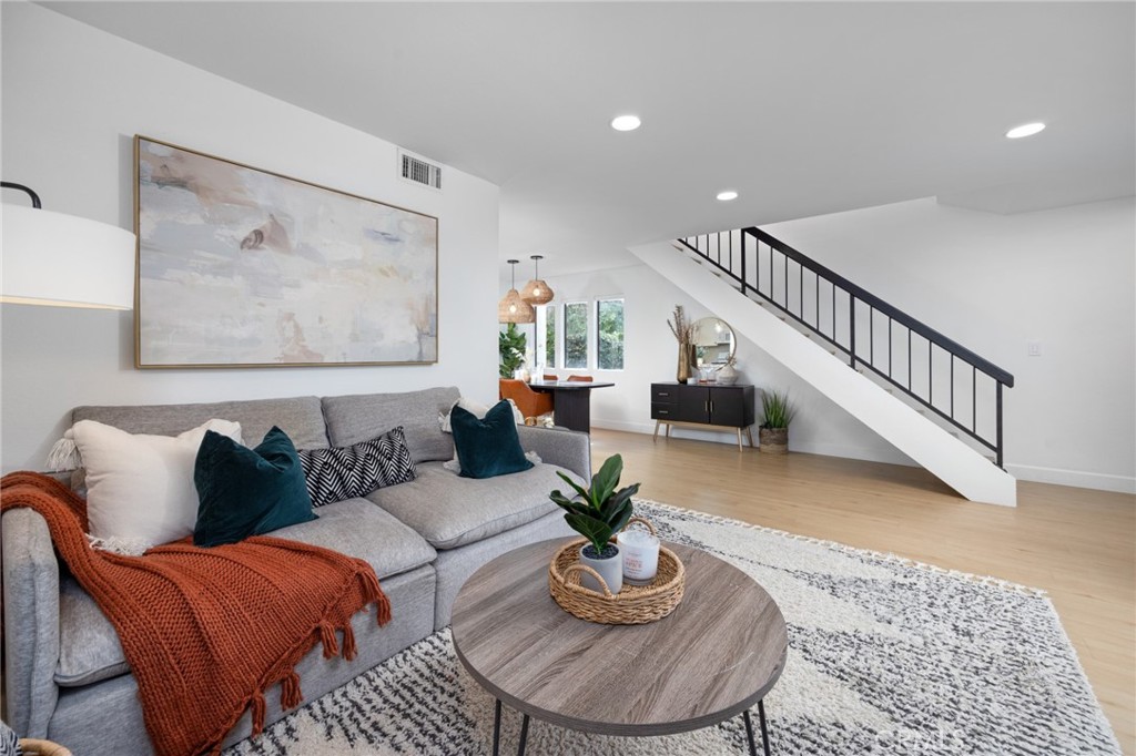 910 Ocean View Avenue, Unit E Monrovia, CA 91016 - Photo 10 of 39 a living room with furniture potted and a rug