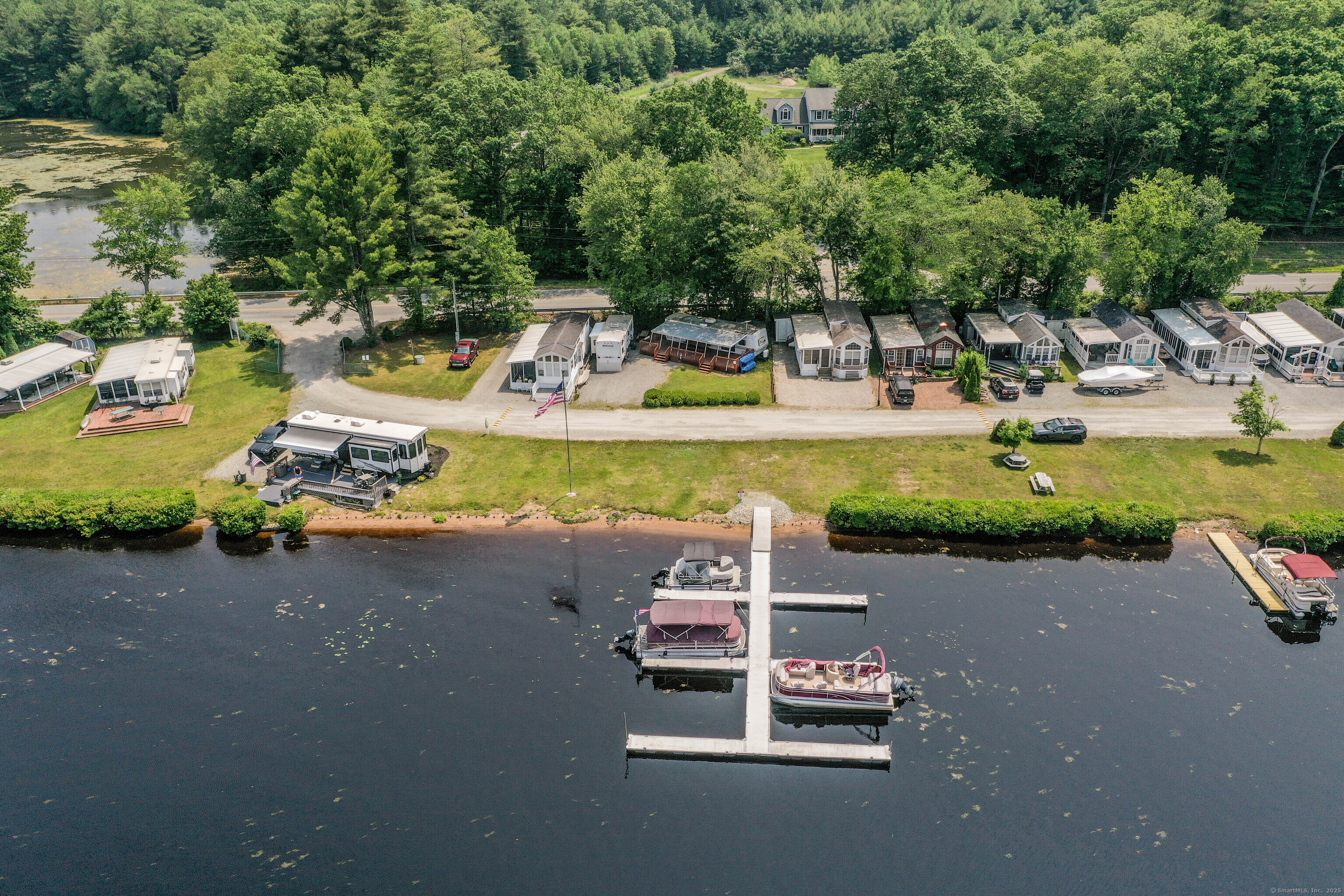 262 Shetucket Turnpike, Unit 2 Griswold, CT 06351 - Photo 1 of 26 a small pool with some trees in the background