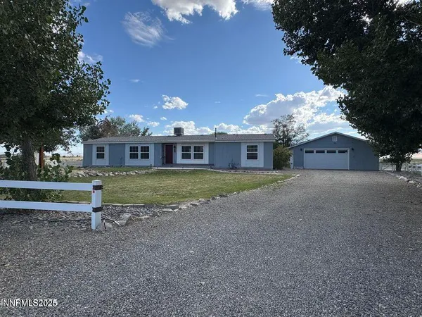 a view of a house with a yard and large tree