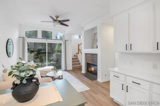 a living room with furniture fireplace and a large window