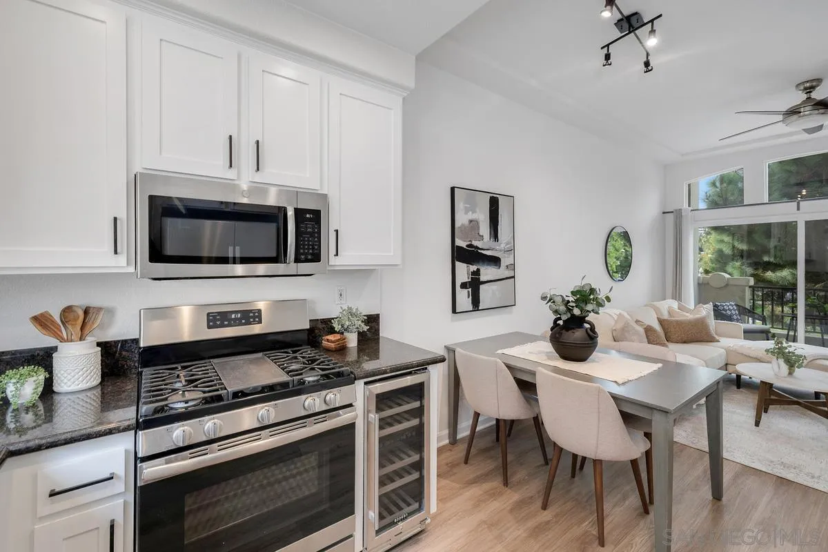 2842 Farragut Road, Unit 131 San Diego, CA 92106 - Photo 14 of 41 a kitchen with stainless steel appliances a dining table and chairs