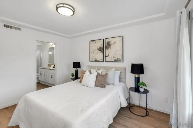 a bedroom with a bed and a lamp on table