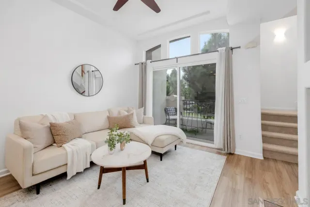a living room with furniture and a floor to ceiling window
