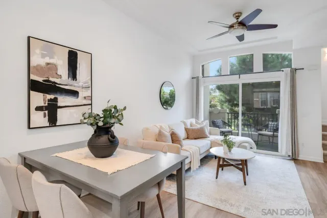 a living room with furniture a table and potted plants