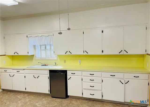 a kitchen with a cabinets and window