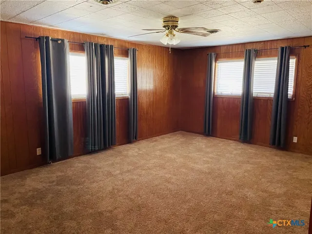 a view of a room with windows and closet