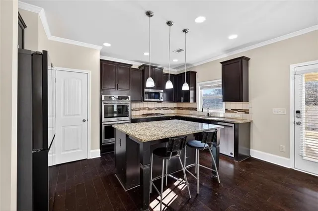 a large kitchen with a table and chairs