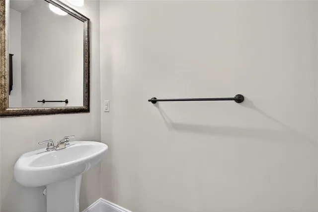 a bathroom with a sink a mirror and shower