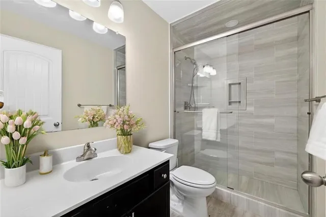 a bathroom with a sink toilet and shower