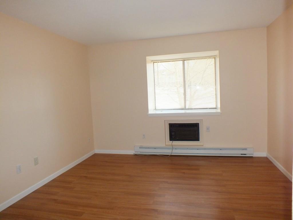 93 Kent Court, Unit 93 Meriden, CT 06450 - Photo 10 of 27 an empty room with wooden floor and windows