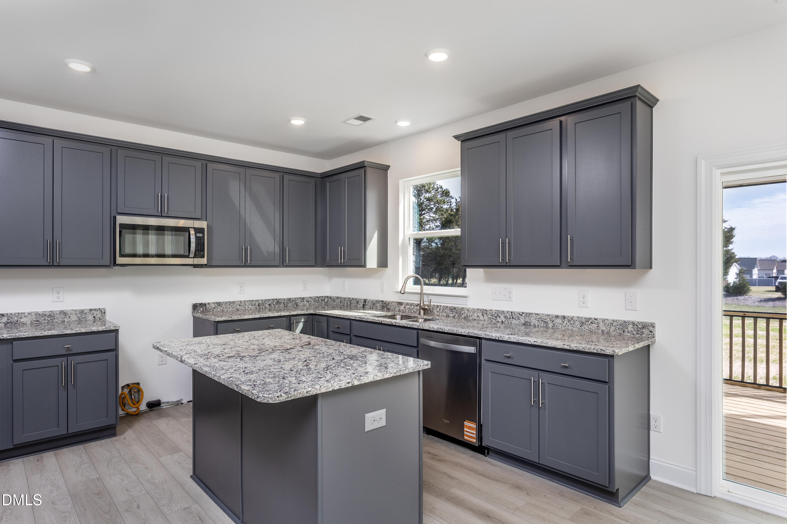 102 Bittersweet Trail Benson, NC 27504 - Photo 11 of 30 a kitchen with stainless steel appliances granite countertop a sink stove and cabinets