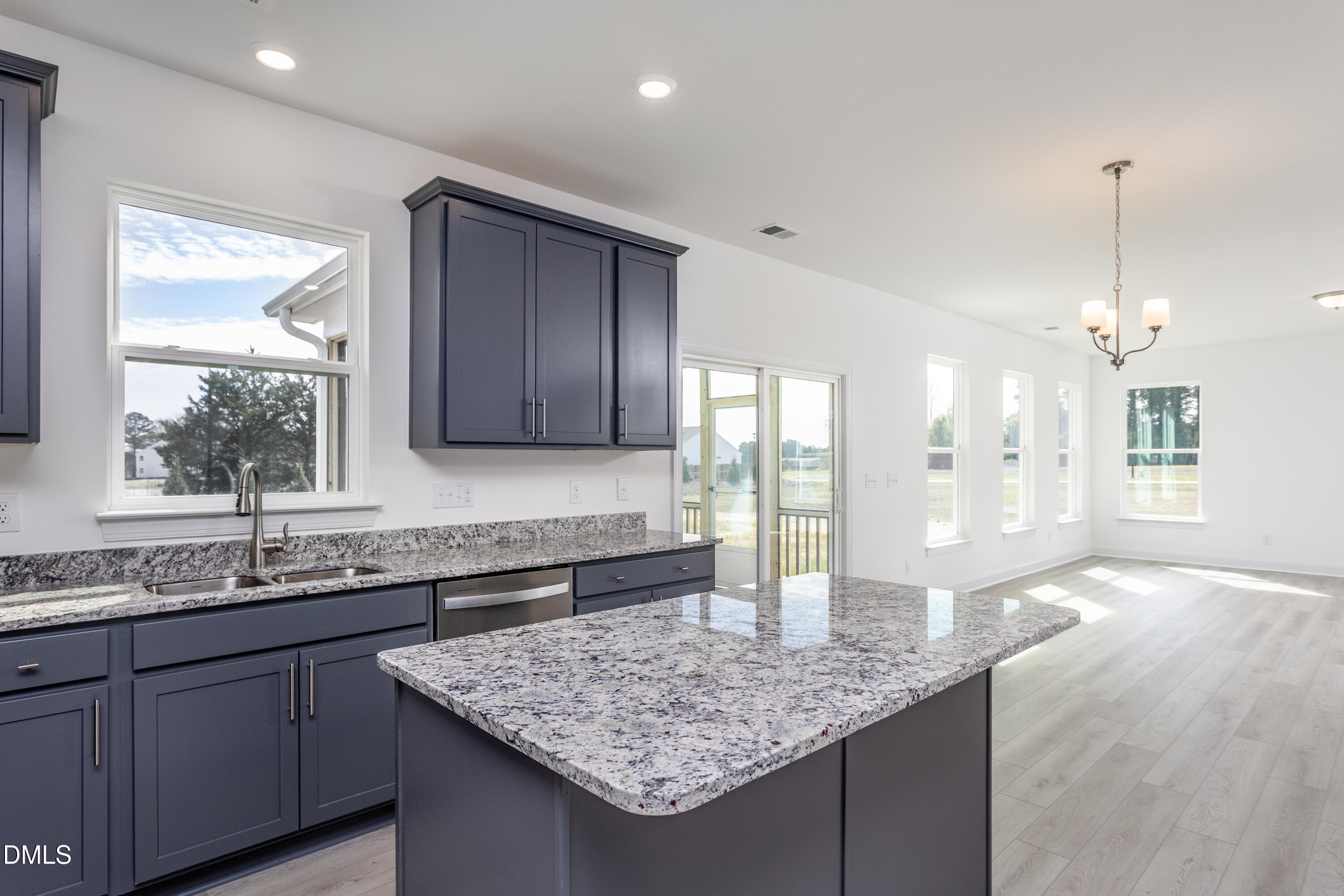 102 Bittersweet Trail Benson, NC 27504 - Photo 12 of 30 a kitchen with granite countertop kitchen island a sink appliances and a counter space