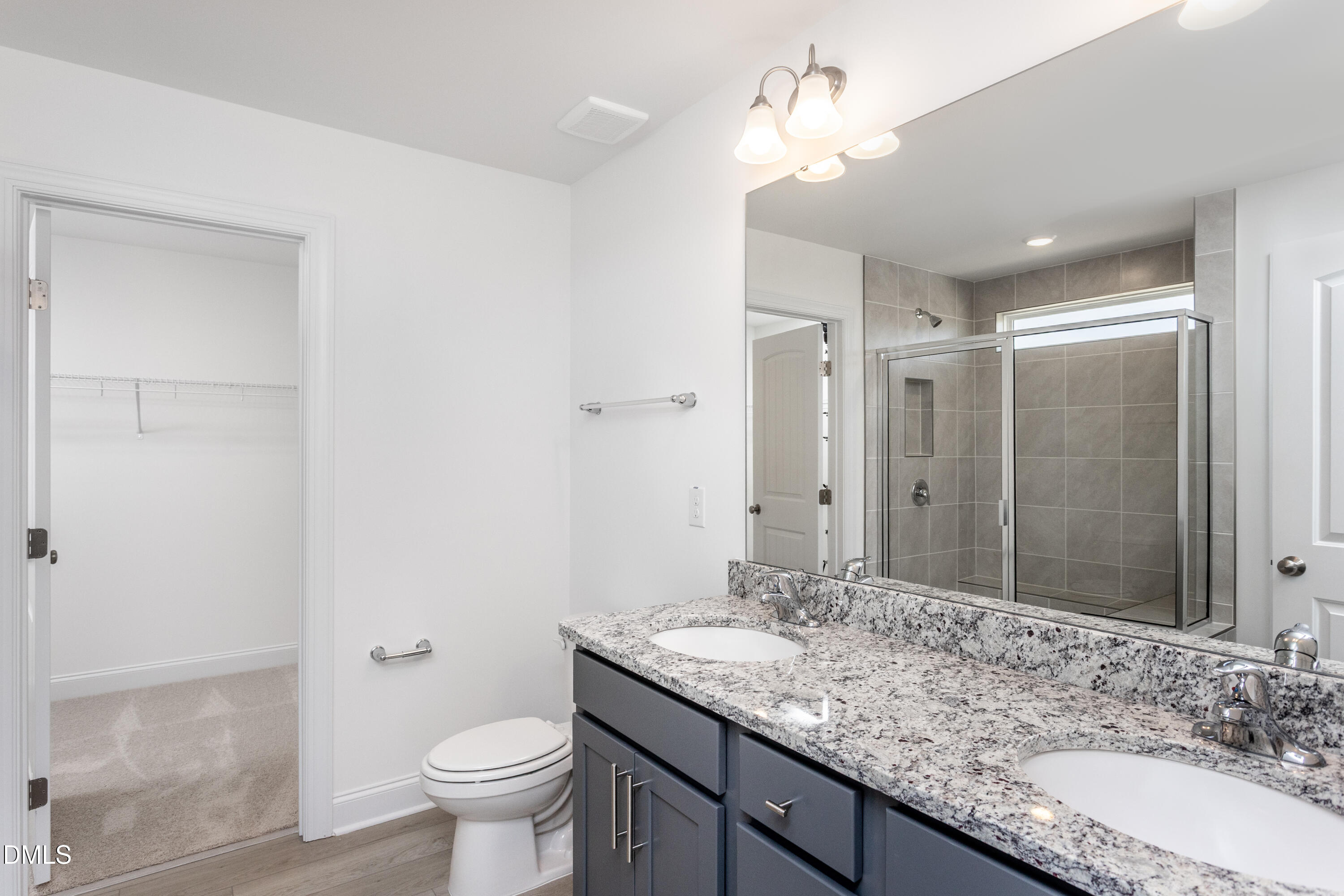 102 Bittersweet Trail Benson, NC 27504 - Photo 23 of 30 a bathroom with a granite countertop sink a toilet a mirror and shower