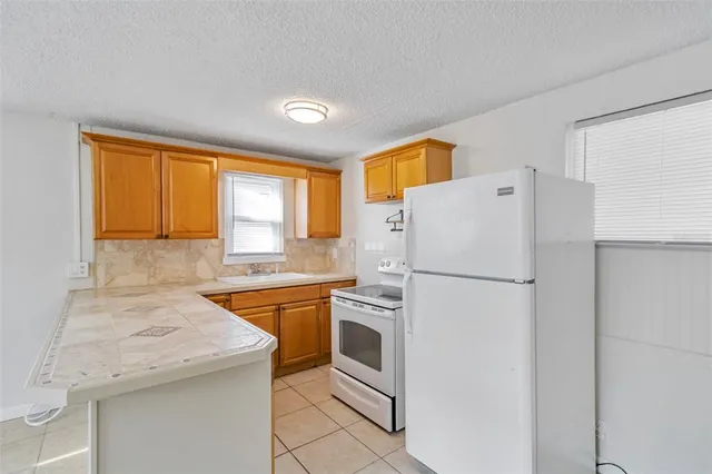 a white refrigerator freezer sitting in a kitchen