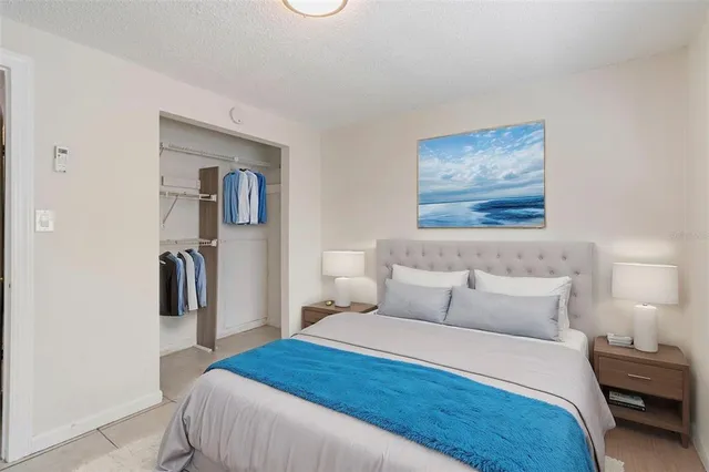 a bedroom with a bed and a painting on the wall