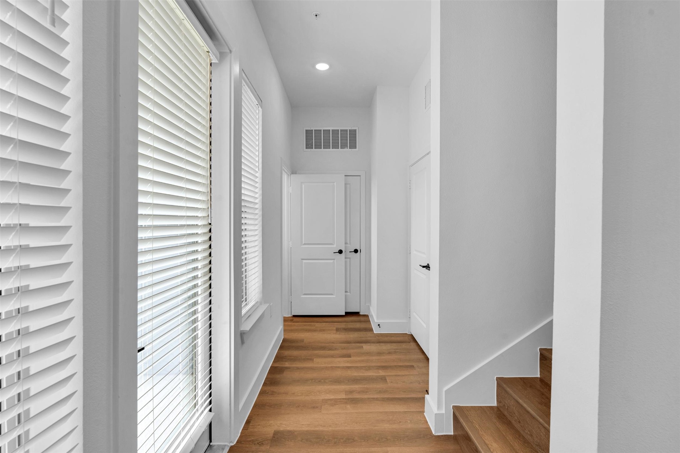 1305 B Goalie Drive Little Elm, TX 75068 - Photo 10 of 38 a view of a hallway with wooden floor and staircase