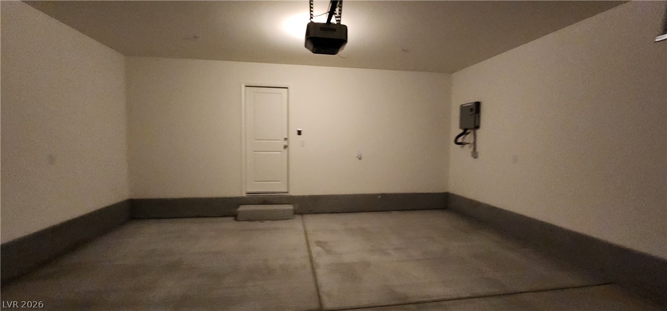 9127 Rory Storm Street Las Vegas, NV 89113 - Photo 9 of 27 A spacious and clean concrete floor garage provides ample storage and utility space.