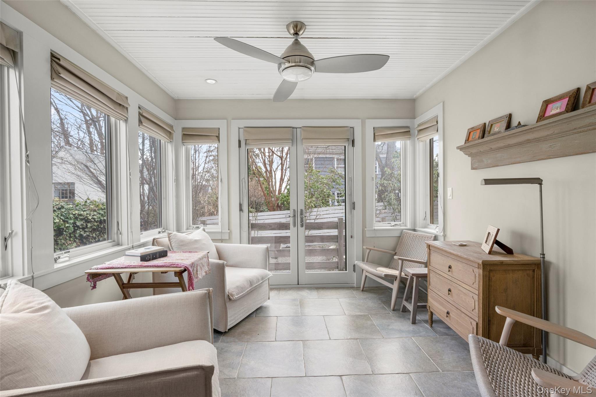 35 Wildwood Road New Rochelle, NY 10804 - Photo 14 of 30 Sunroom with radiant heated floor, ceiling fan, and doors to Bluestone Patio