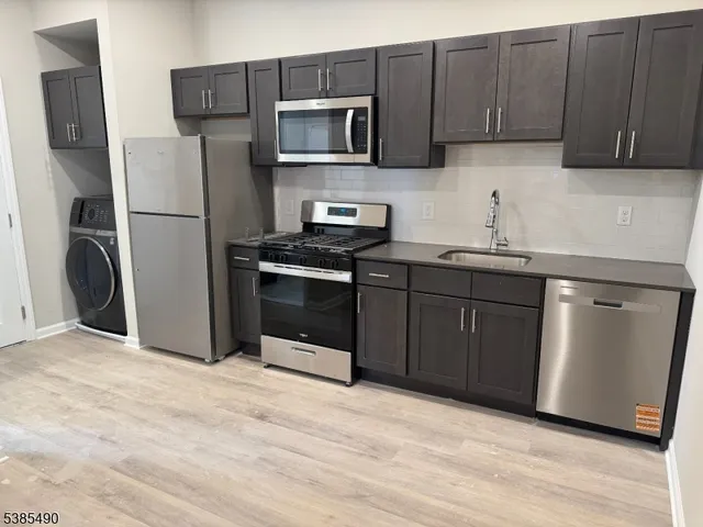 a kitchen with a sink and a refrigerator