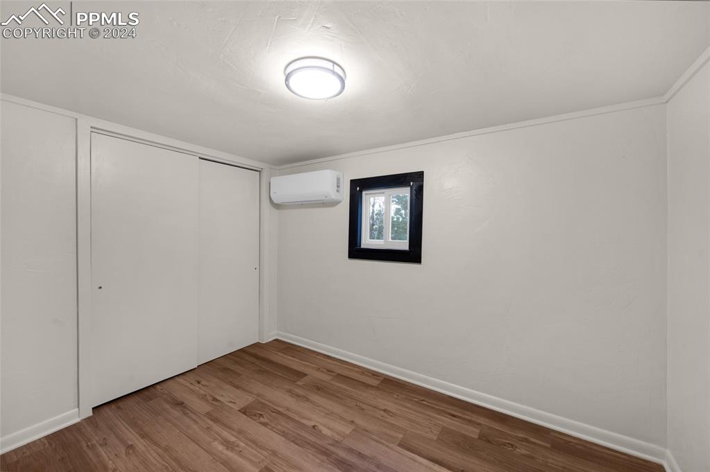 53 Iris Road Woodland Park, CO 80863 - Photo 15 of 27 a view of an empty room with wooden floor and a window