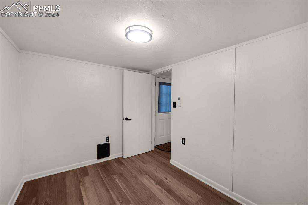 53 Iris Road Woodland Park, CO 80863 - Photo 16 of 27 a view of an empty room with wooden floor
