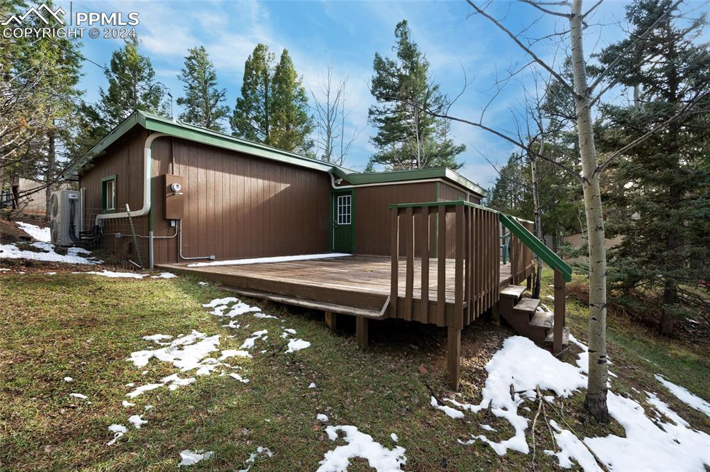 53 Iris Road Woodland Park, CO 80863 - Photo 20 of 27 a backyard of a house with large trees and wooden fence