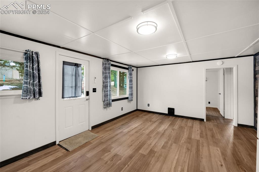 53 Iris Road Woodland Park, CO 80863 - Photo 9 of 27 a view of an empty room with wooden floor and windows